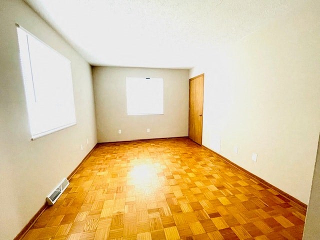 an empty room with a wooden floor and a window