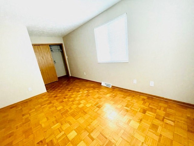 an empty room with a wooden floor and a door