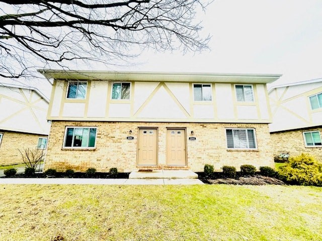 a yellow brick house with a wooden front door