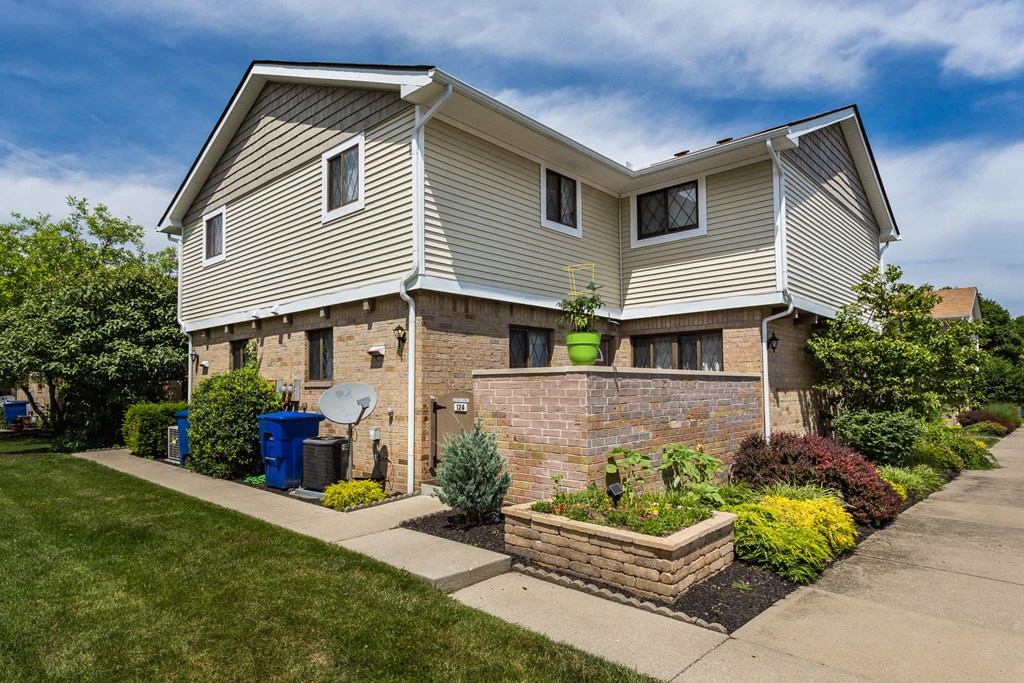 a house with a yard and a sidewalk in front of it