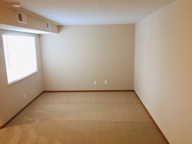 an empty room with a window and a wooden floor