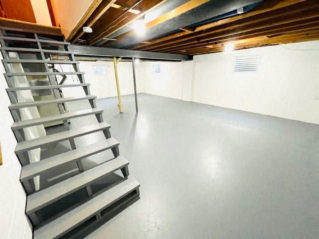 a set of stairs in a room with a concrete floor