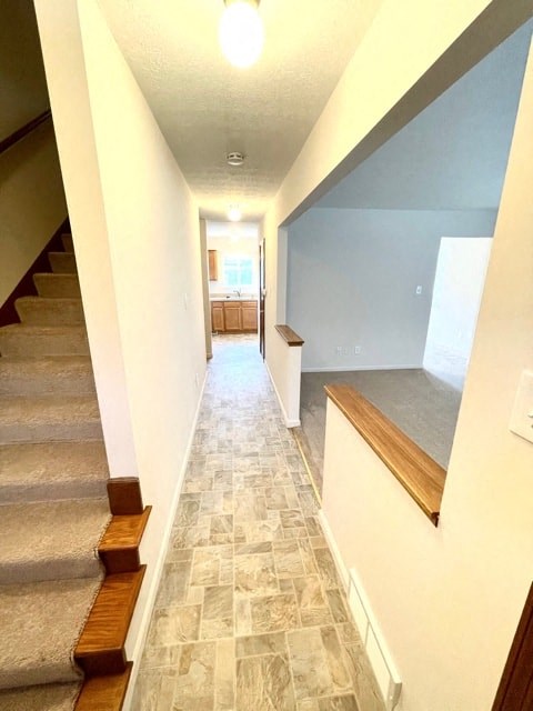 a hallway with a staircase and a hall way with stairs