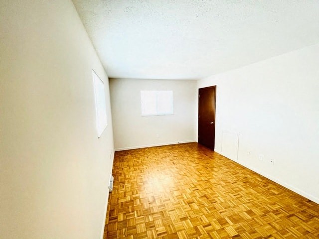 an empty room with a wood floor and a door