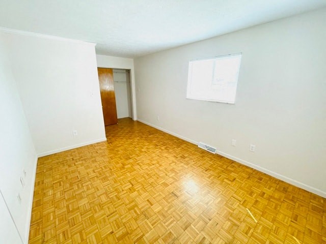 an empty room with a wood floor and a white wall