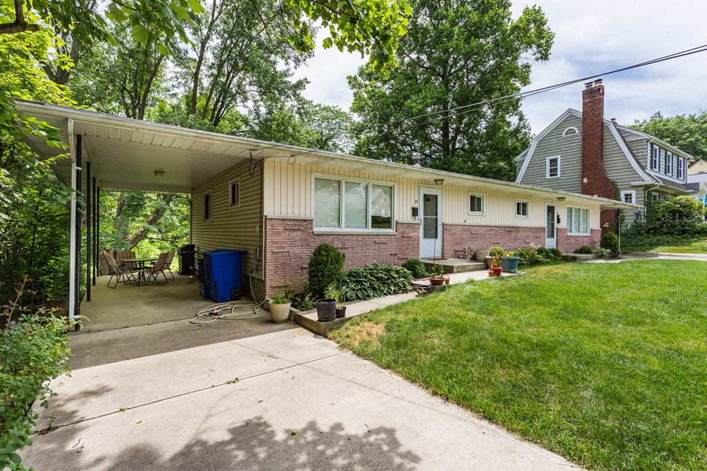 the front of a house with a yard and a driveway