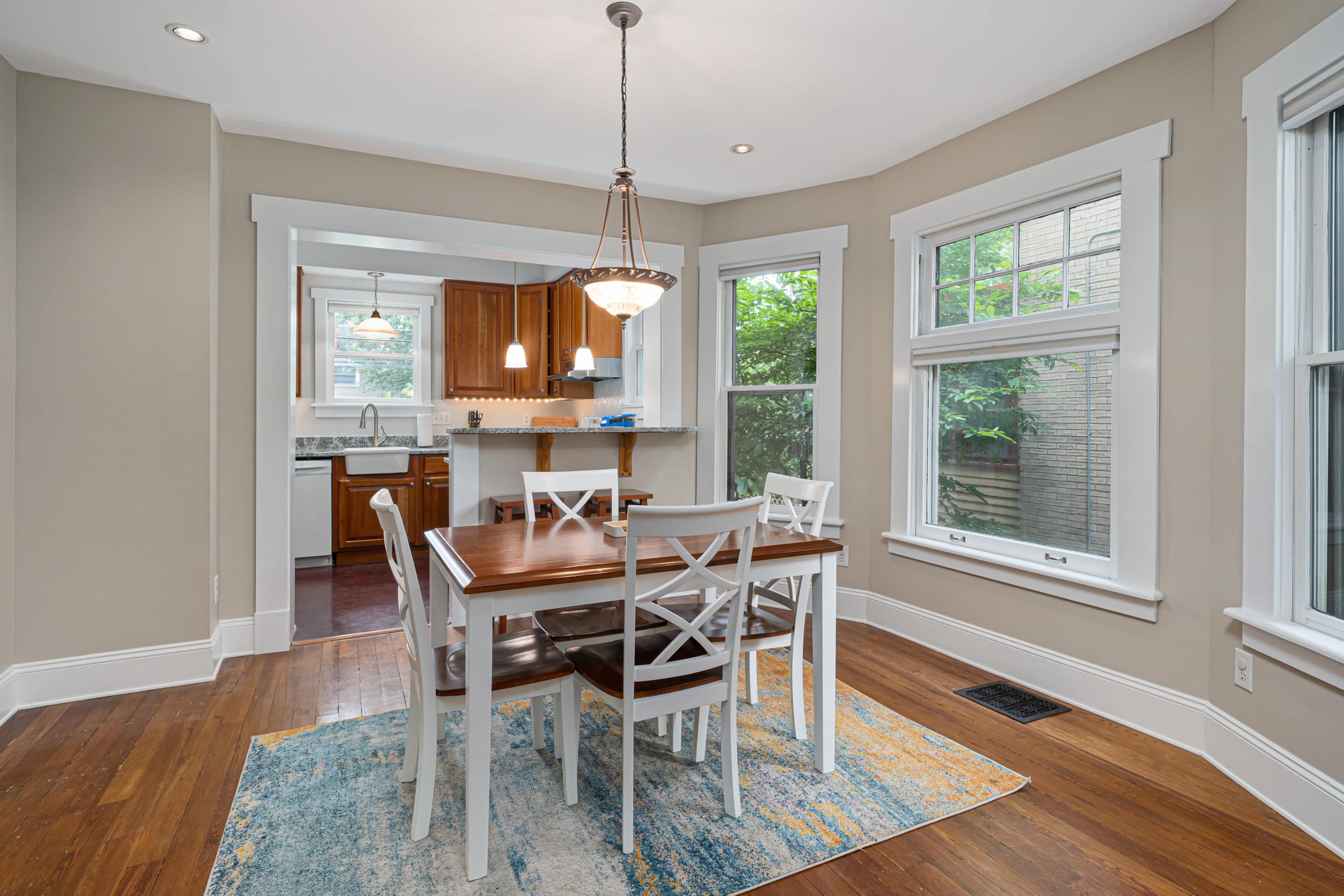 A dining room with a table and chairs.