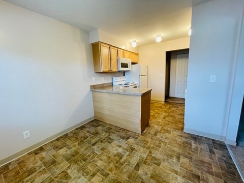 A kitchen area with a microwave, oven, and sink.