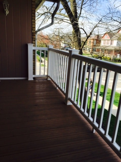 a deck with a view of the yard and a house