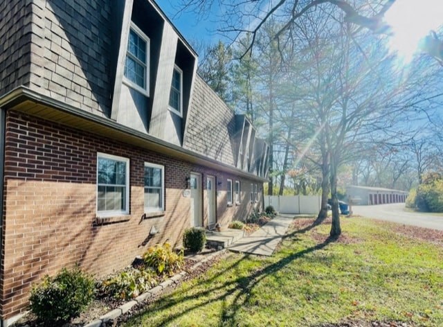 a brick house with a sidewalk in front of it