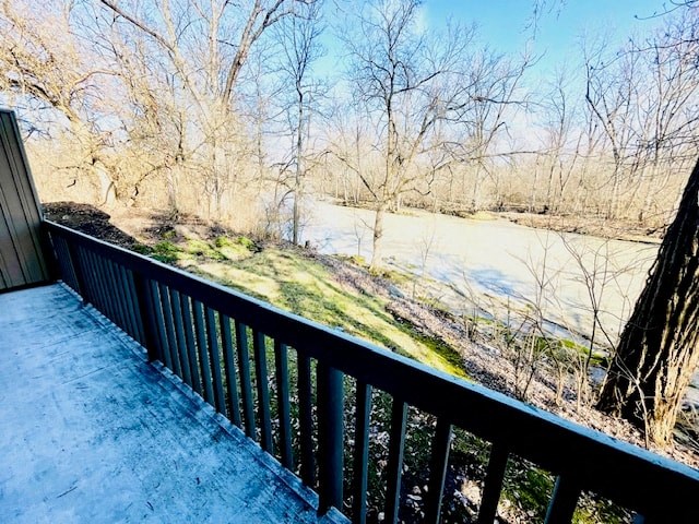 a balcony with a view of a river and trees