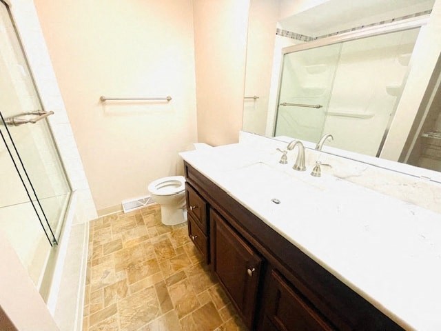 a bathroom with a sink and a shower and a toilet