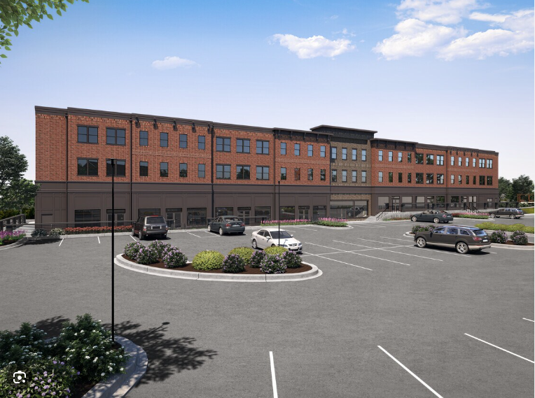 a large brick building in a parking lot