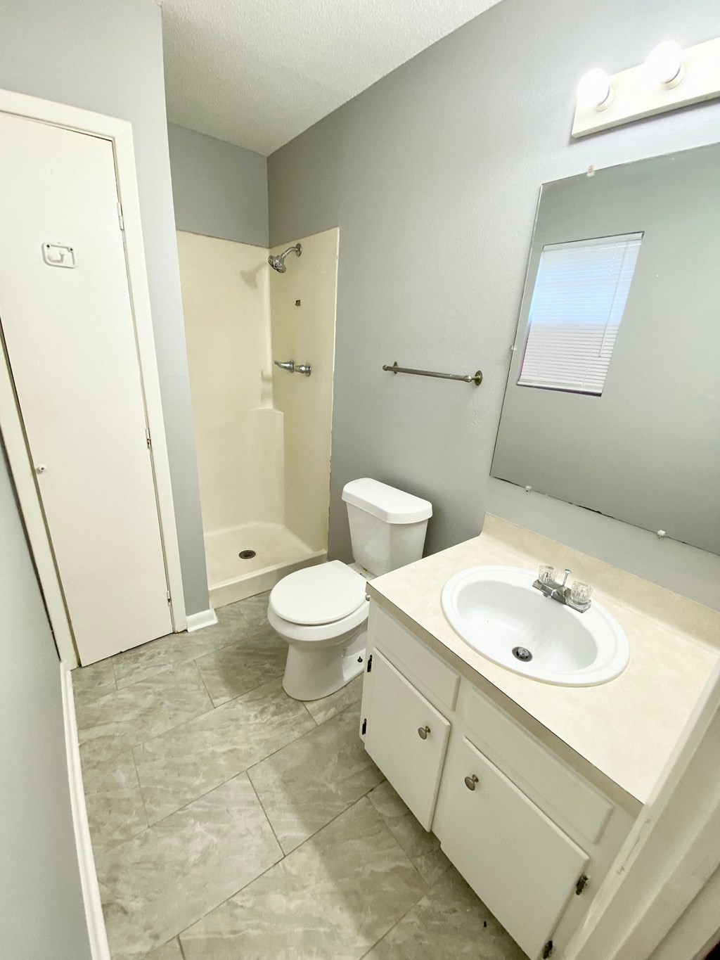 a bathroom with a sink toilet and a mirror