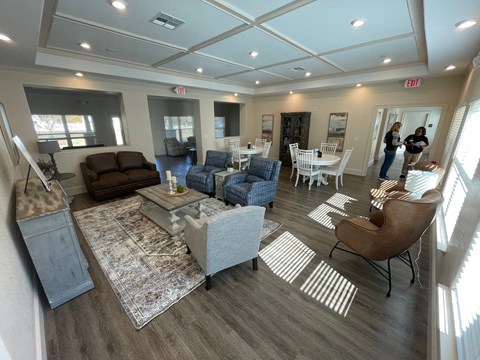a view of a living room with couches and chairs and a dining room table