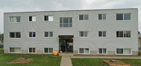 a large white building with windows and a door