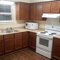 a kitchen with a stove microwave and a sink