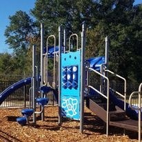 a playground with a blue gate