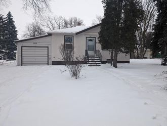 a house in the snow with a garage
