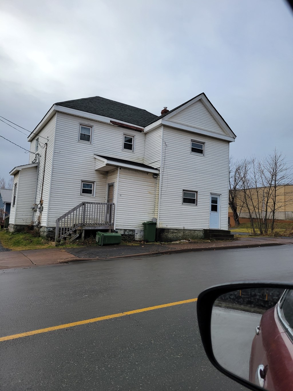 a white house on the side of the road
