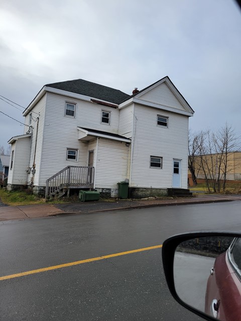 a white house on the side of the road
