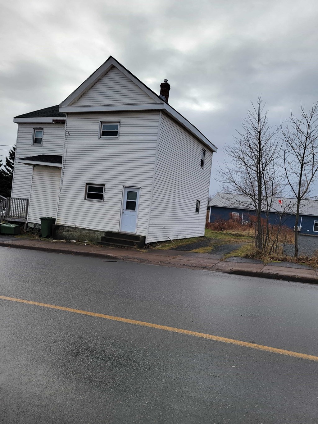 a white house on the side of a road