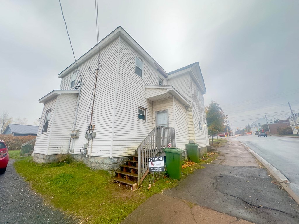 a white house on the side of a street