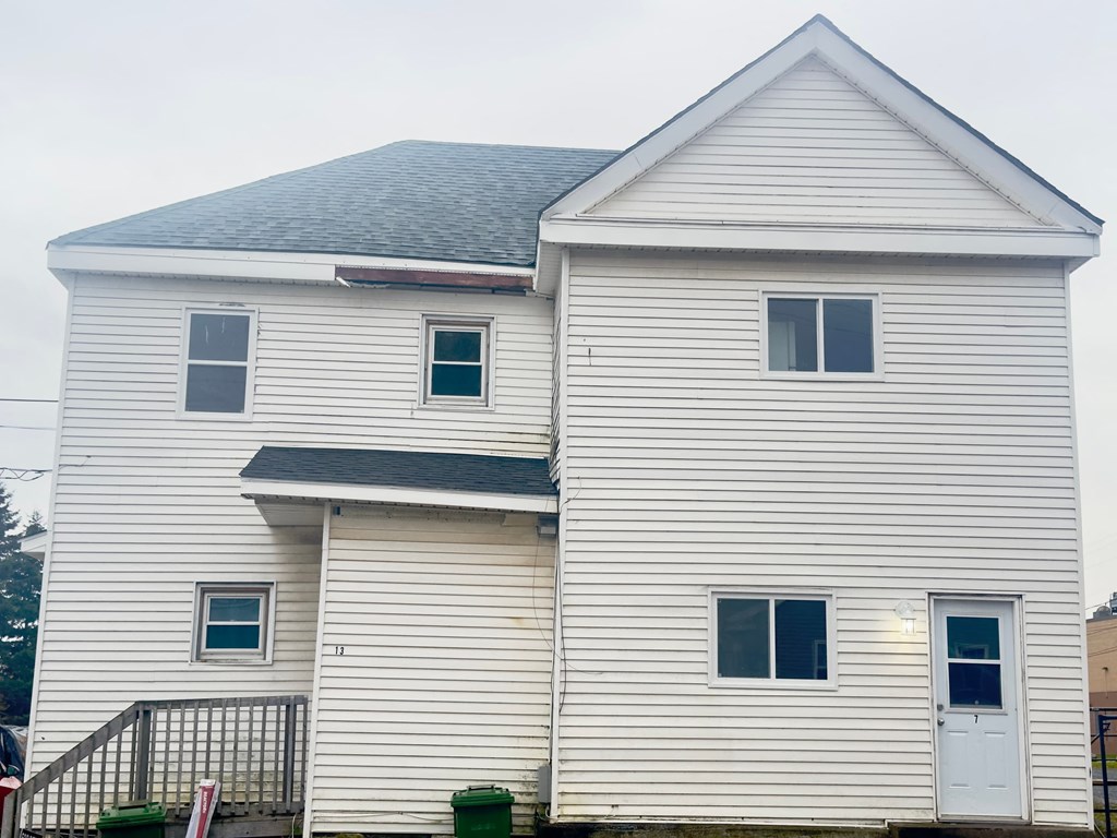 a white house with white siding and a gray roof