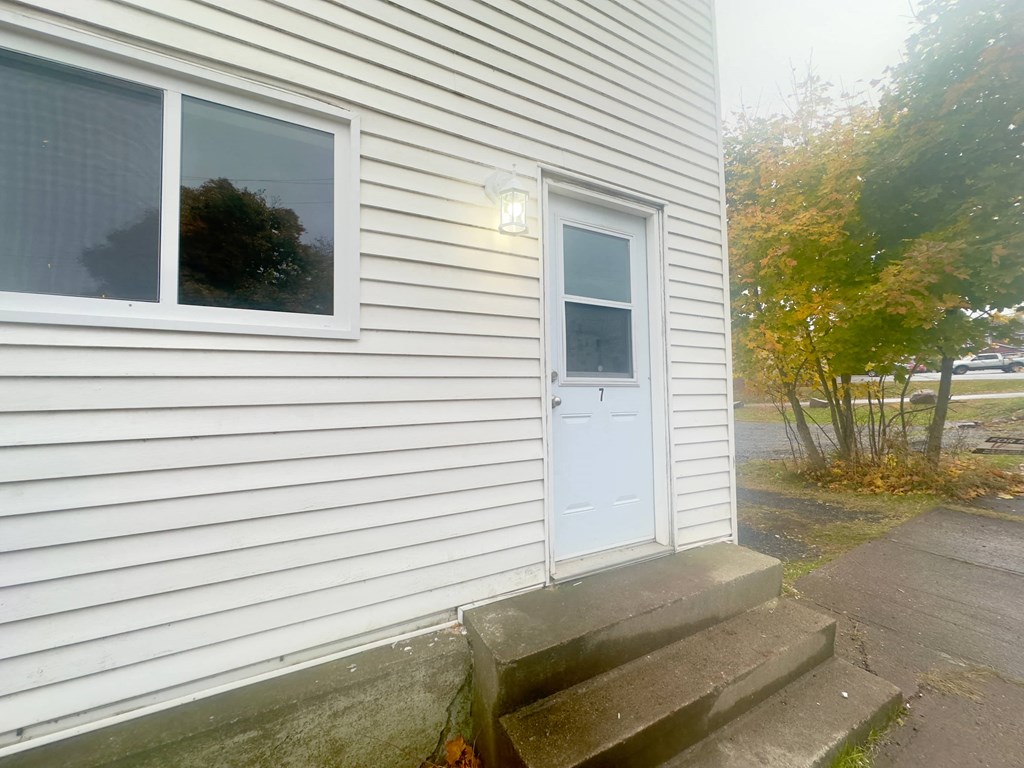 a white house with a white door and two windows