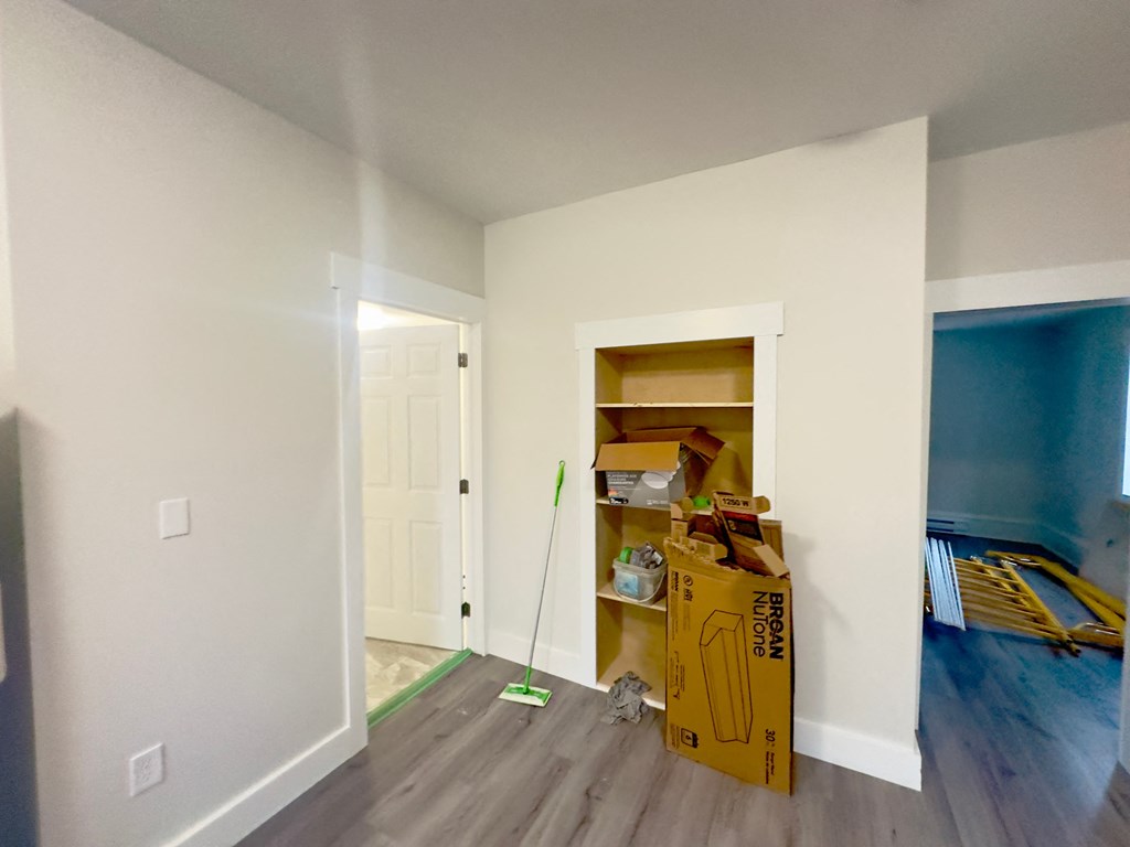 a room that is being remodeled with boxes on the floor and a white wall