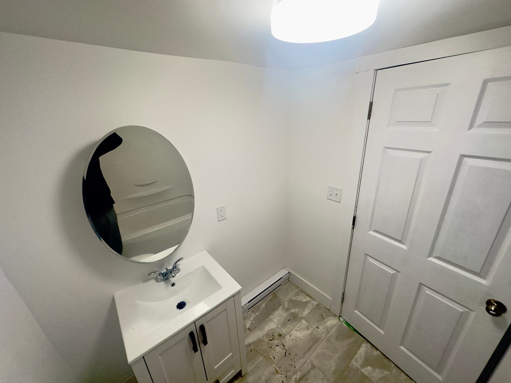 a bathroom with a mirror and a sink and a white door