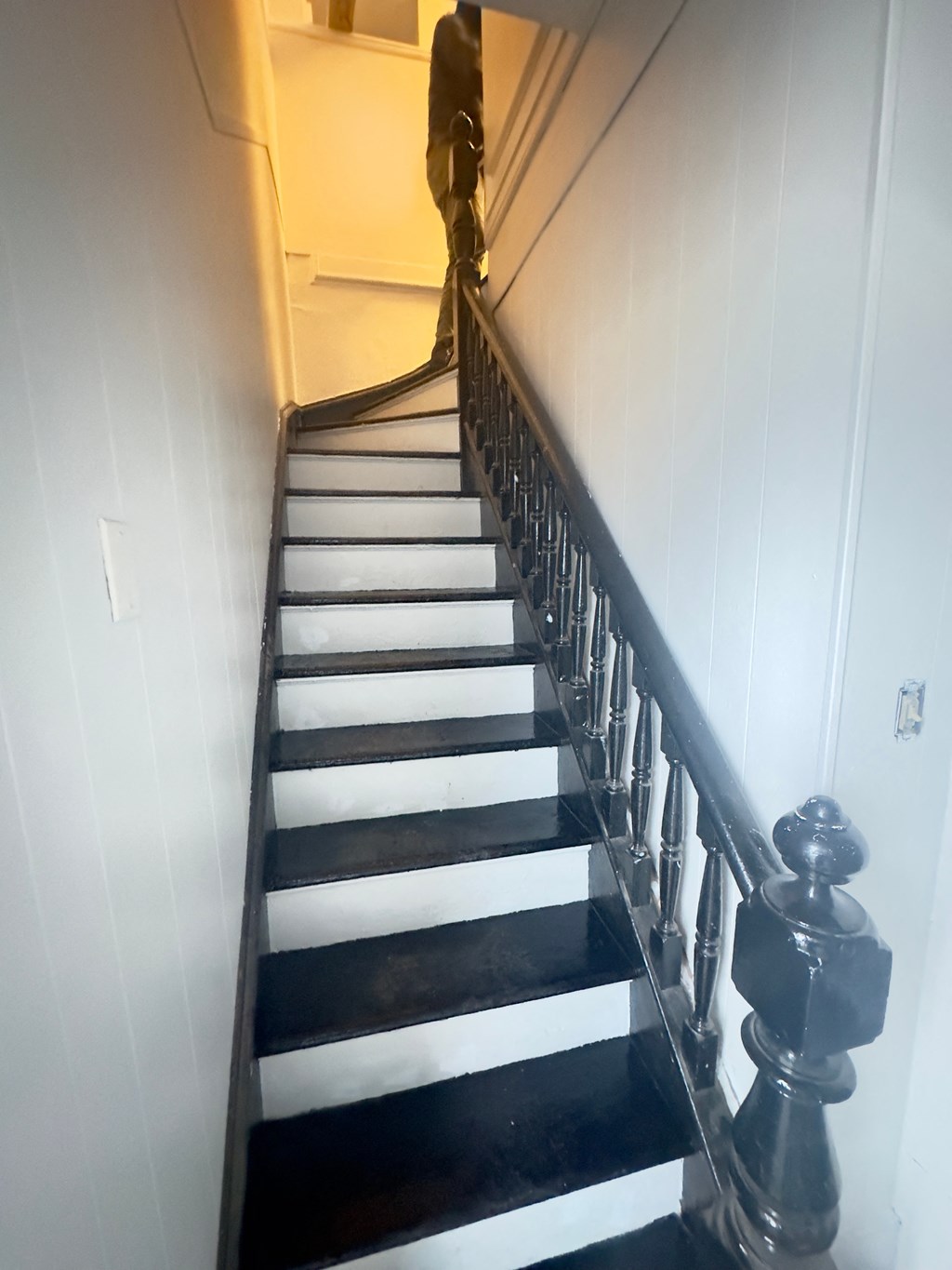 a man walking down the stairs of a house