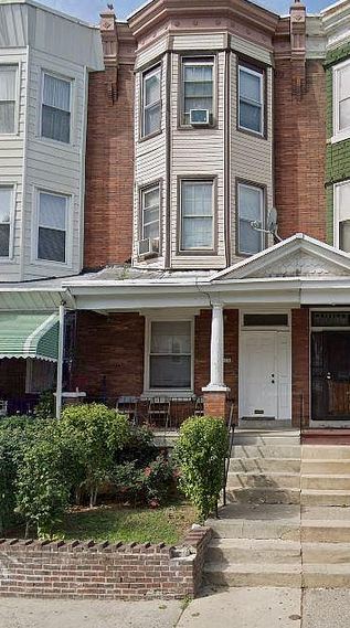 a house with a porch and a white door
