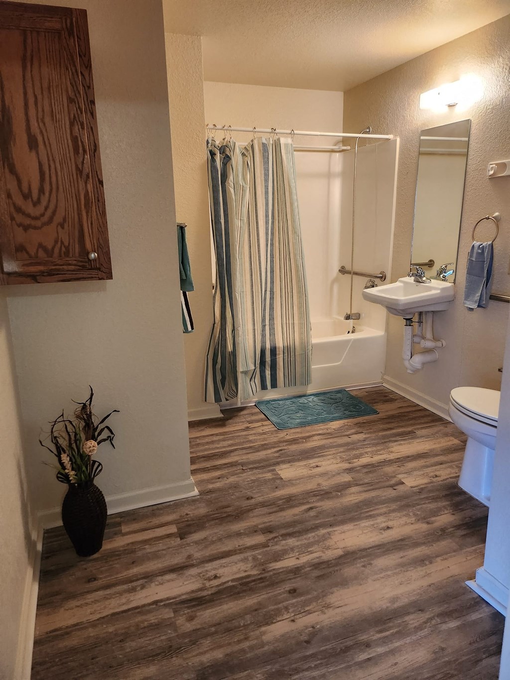 a bathroom with a shower and a toilet and a sink