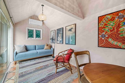 a living room with a couch and a table and a window