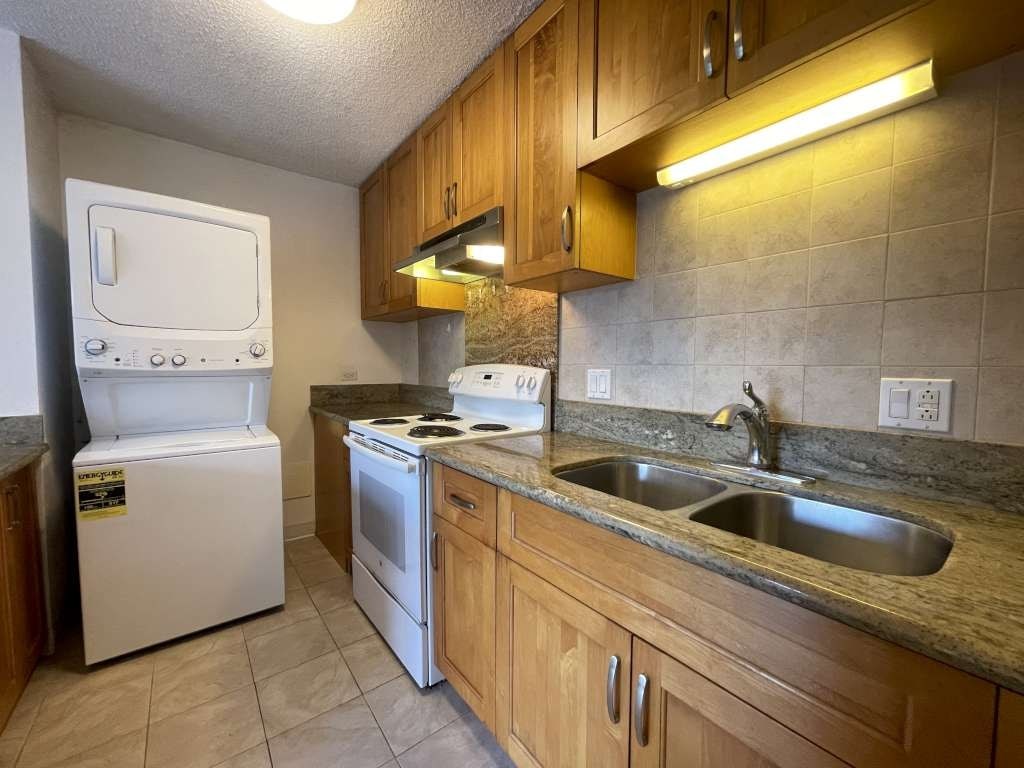 A kitchen with a white oven and a white dishwasher.