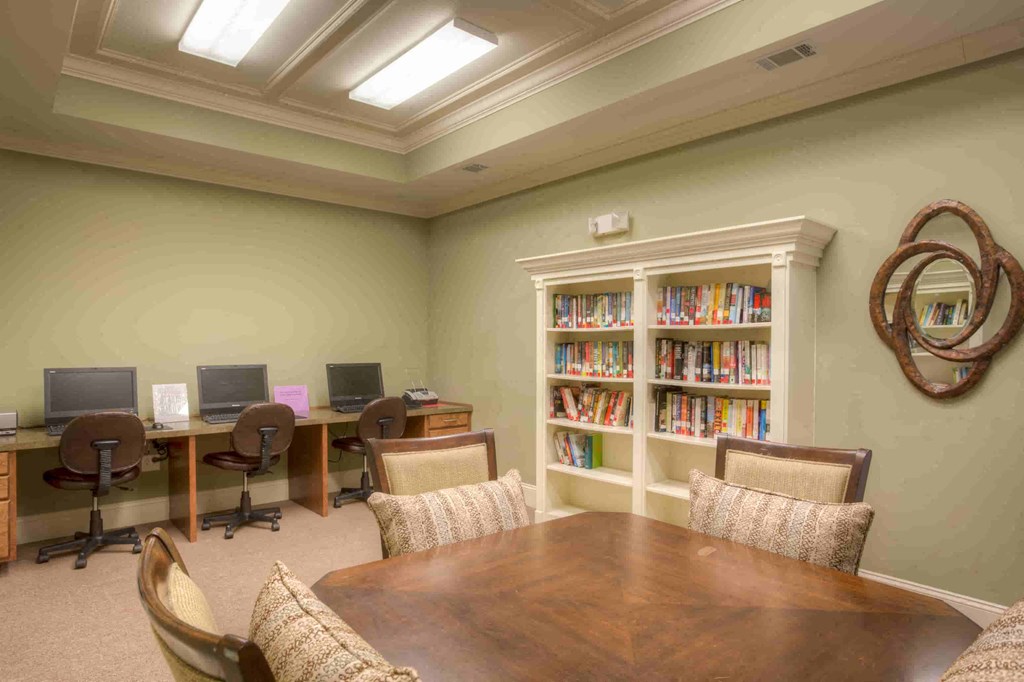 a conference room with a table and chairs and a library