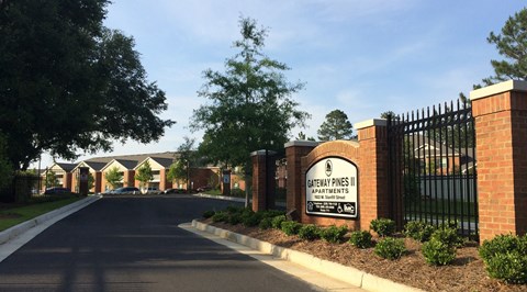 a brick building with a sign on the side of a road