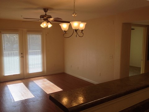 a dining room with a table and a ceiling fan
