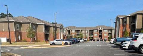 an empty parking lot in front of an apartment building
