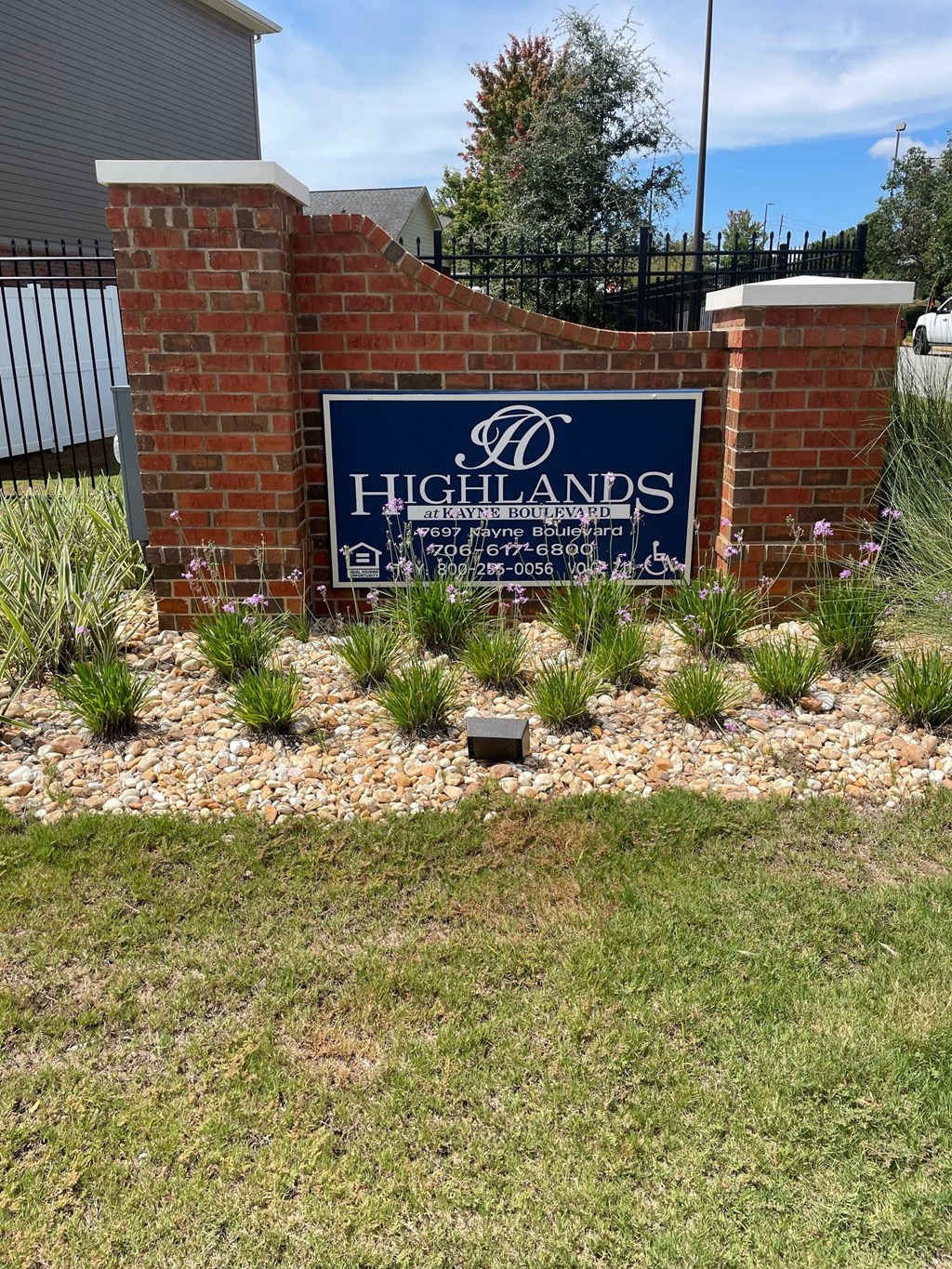 a sign in front of a brick wall