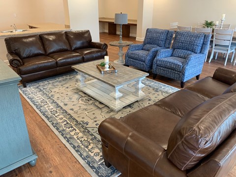 a living room with leather couches and a coffee table