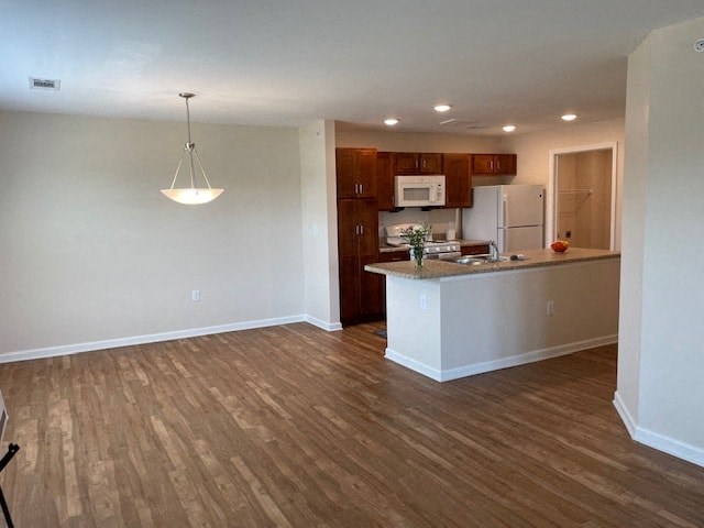 an empty living room and kitchen with a wood floor