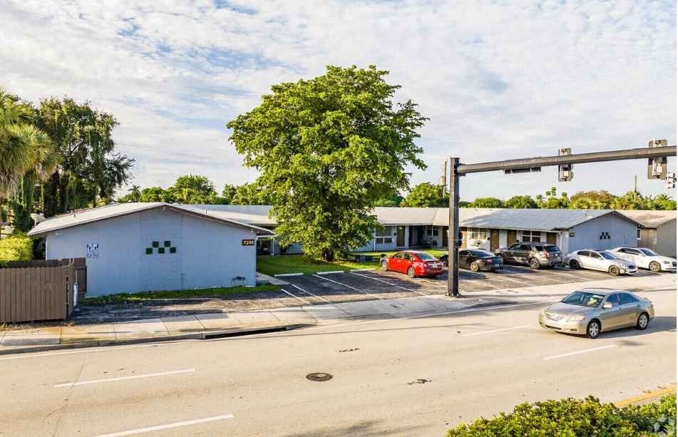 a parking lot with cars in front of a building