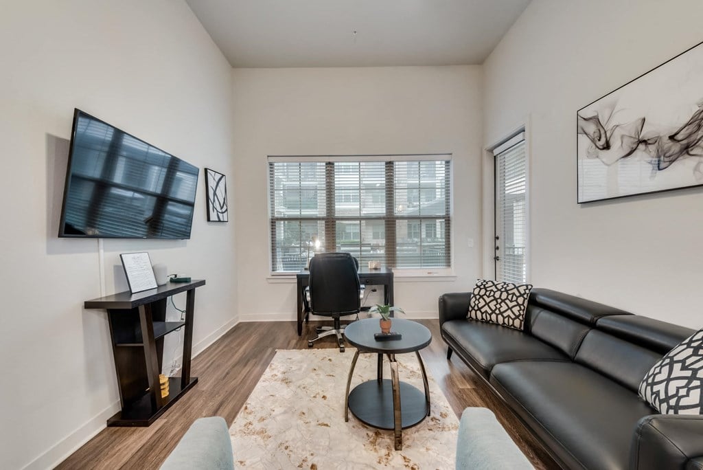 a living room with a leather couch and a table