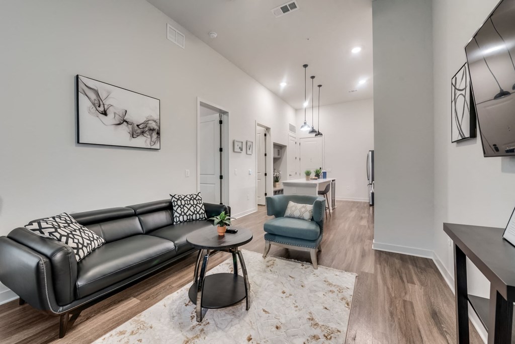 a living room with leather furniture and a rug