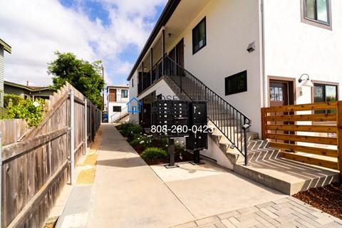 a building with stairs and a sidewalk in front of it