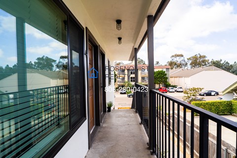 a balcony with a view of the parking lot