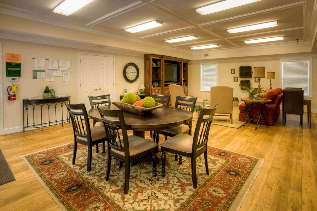 a dining room and living room with a table and chairs