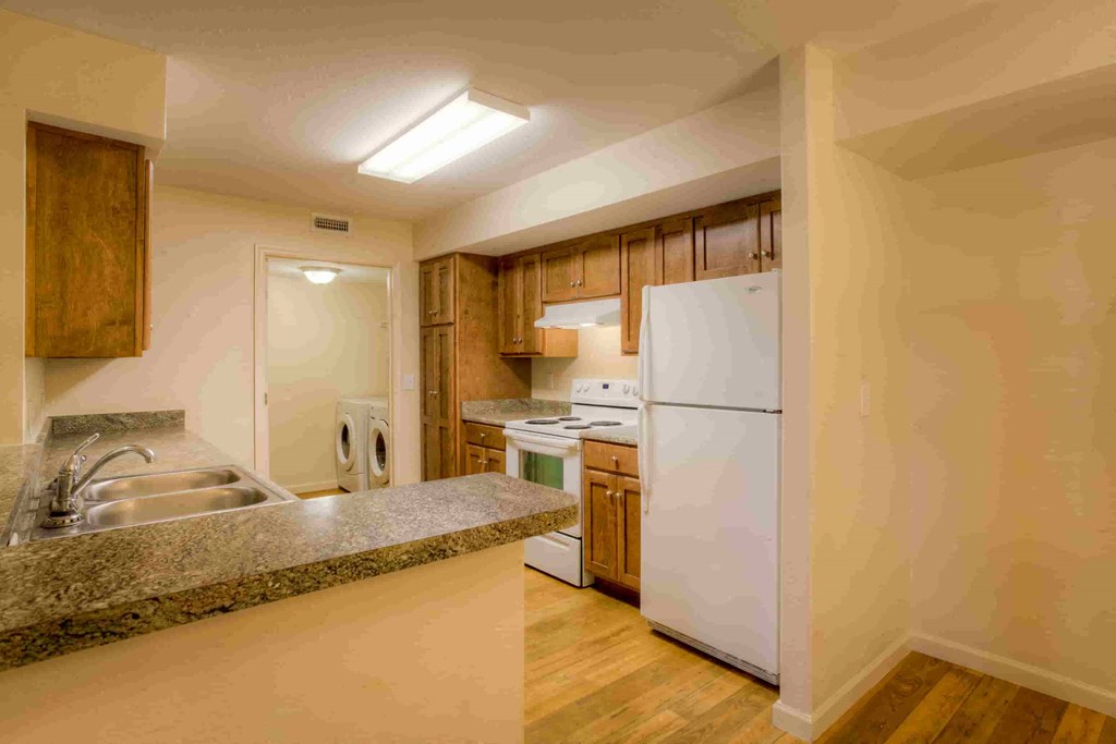 a kitchen with a sink and a refrigerator